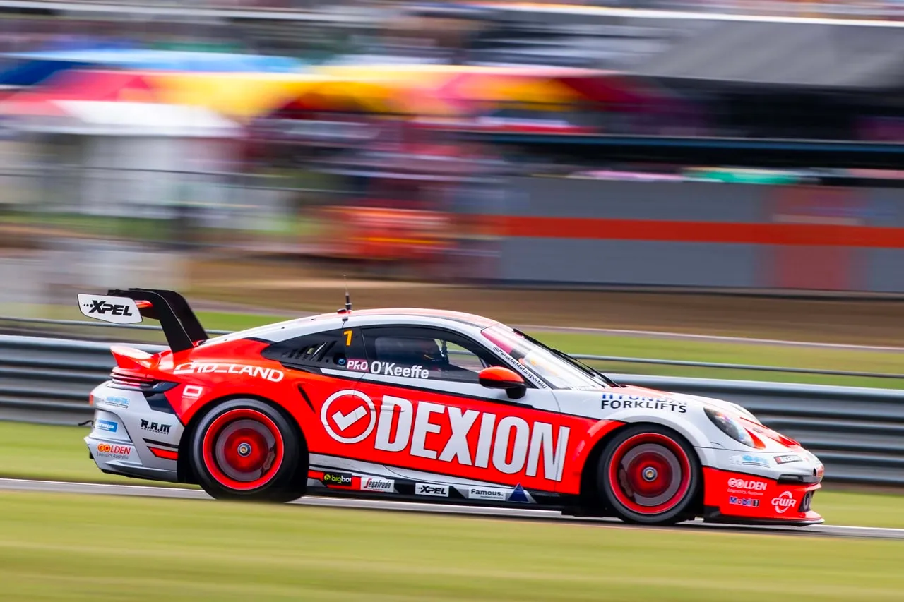 Side view of the Dexion Porsche 911 GT3 Cup car speeding past with motion blur