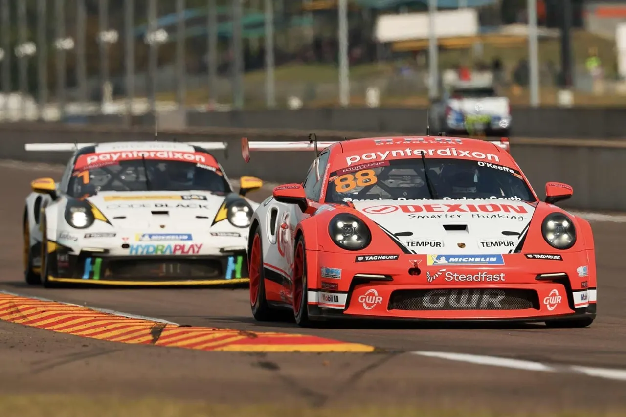 Dexion Porsche #88 racing closely alongside a white Porsche