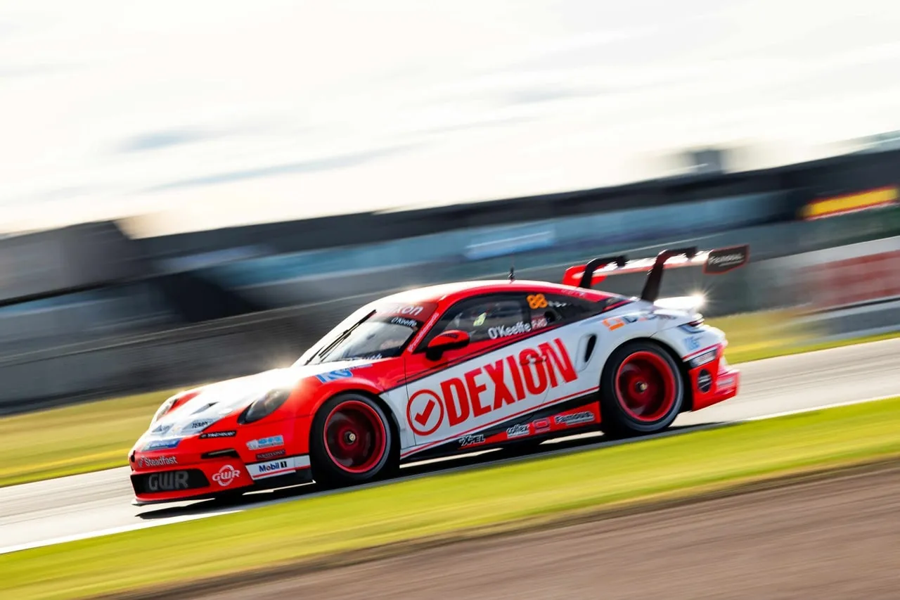 Dexion Porsche 911 GT3 Cup car speeding past in warm light with motion blur