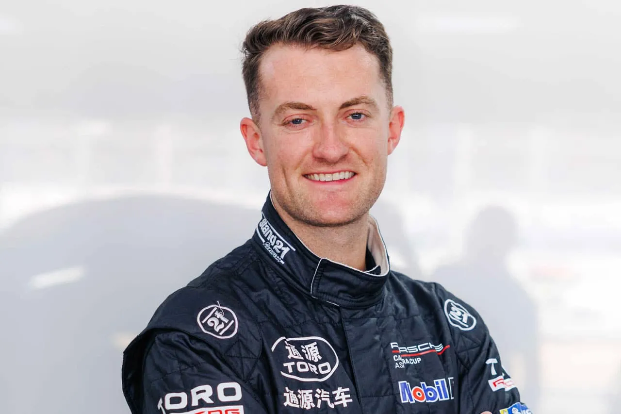 Portrait of Dylan O’Keeffe smiling in a black Toro Racing race suit