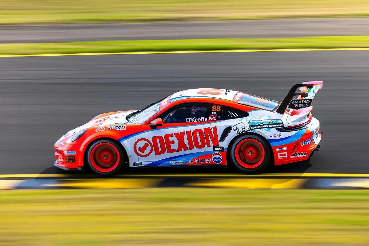 Side view of the number 88 Dexion Porsche 911 GT3 Cup car at speed on track