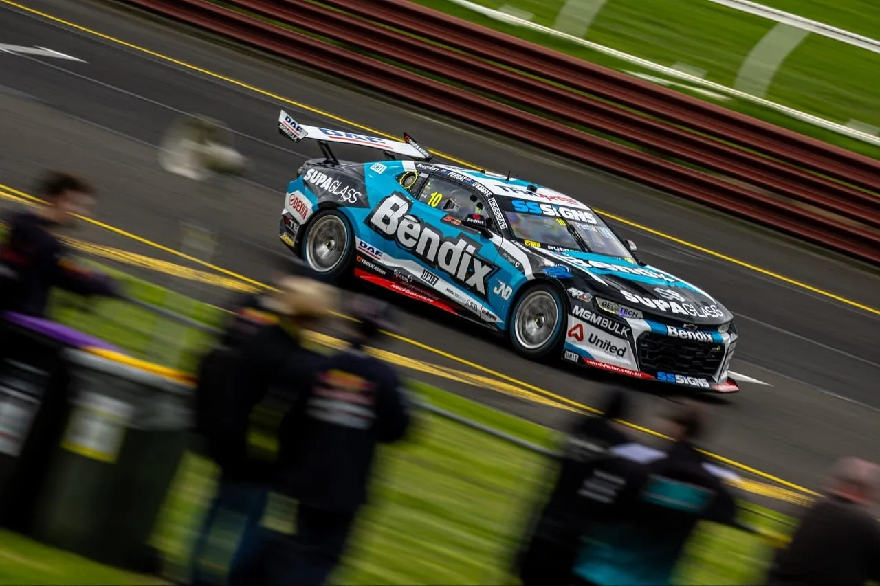 Bendix Supagas Chevrolet Camaro Supercar at speed past blurred trackside spectators