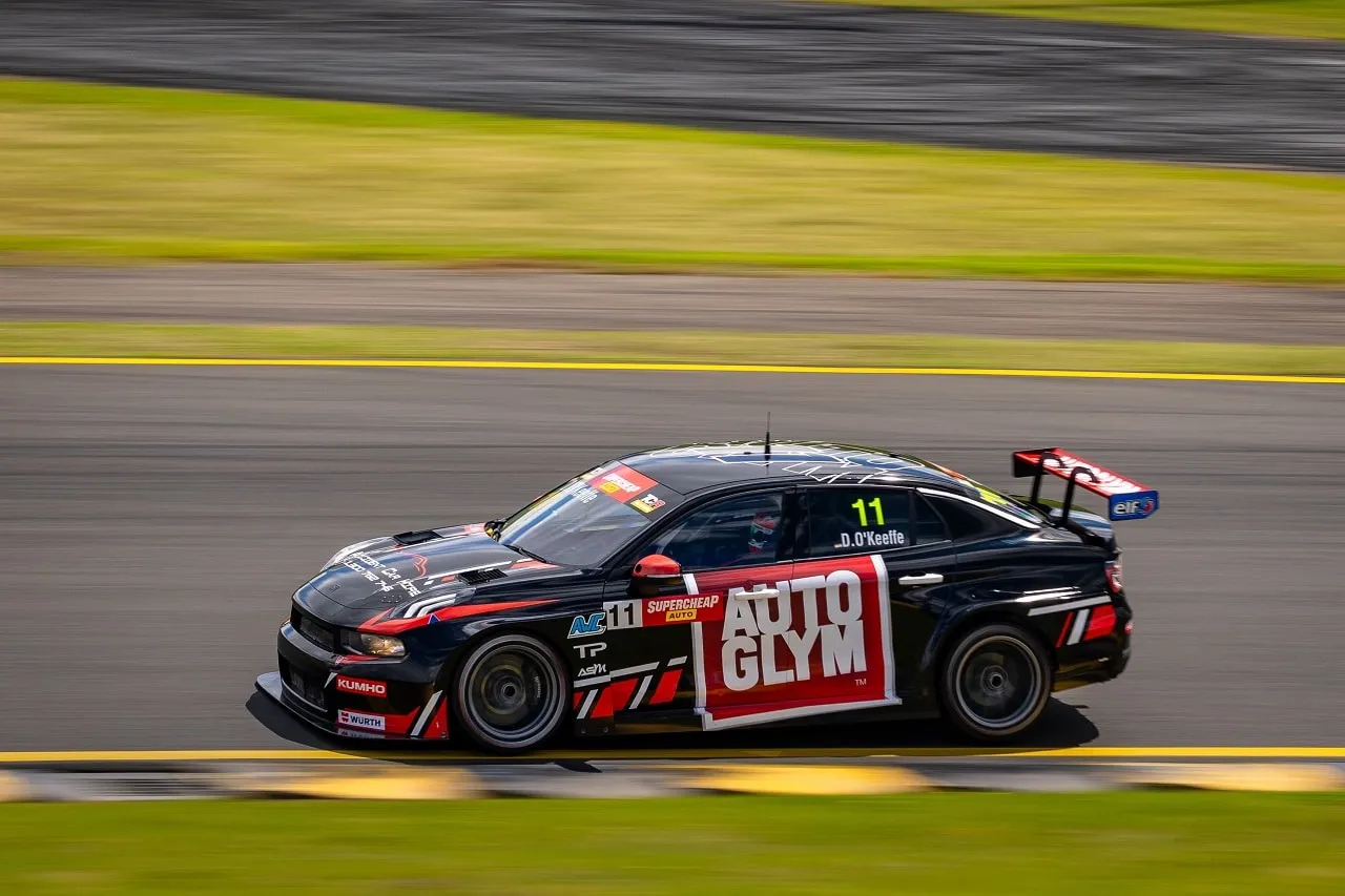 Black number 11 Autoglym Lynk & Co TCR car driven by D. O’Keeffe at speed on a circuit