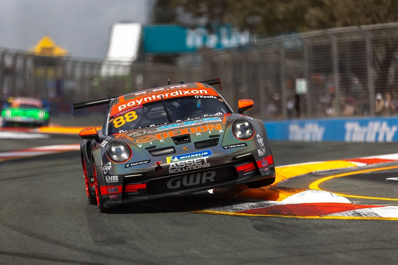 Number 88 Porsche Carrera Cup car in grey and orange Dexion and Asset Solutions livery cornering on a street circuit