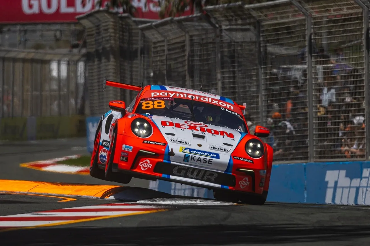 Number 88 Dexion Porsche 911 GT3 Cup car with a wheel lifted over a kerb on a street circuit